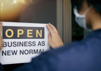 The Budd Group open sign that reads, "Open: Business as New Normal" Your New Normal: Top 7 Office Reopening Guidelines