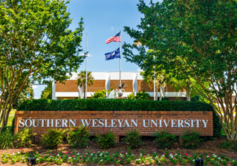 a sign for southern wesleyan university in front of a building on campus COVID-19 Disinfection: The Budd Group Helps SWU Campus Get Ready for Reopening