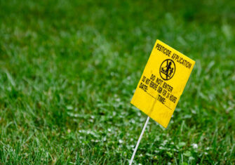 Landscape site with pesticide hazard sign Safety Hazards of Commercial Landscaping