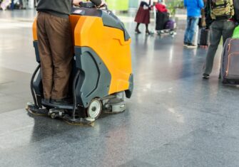 Person using a commercial floor cleaner Top Tips for Commercial Floor Care Projects This Summer