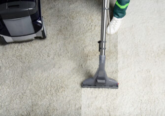 Carpet cleaner cleaning a white commercial carpet How to Ensure You Fully Clean Commercial Carpet