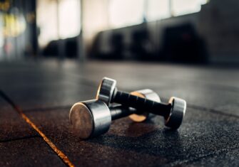 Dumbells on a gymnasium floor Update Your Gym with Commercial Rubber Flooring