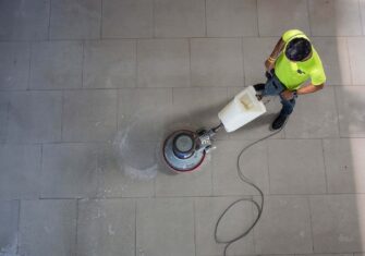 Man cleaning the floor of a facility using a commercial floor cleaning machine Cleaning Technology & Chemical Free Floor Stripping