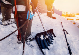 Workers shoveling in the snow How to Prepare Your Facility for Winter this Year