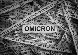 Pieces of newspaper Omicron: Top 5 Fast Facts About the New Dominant COVID-19 Variant