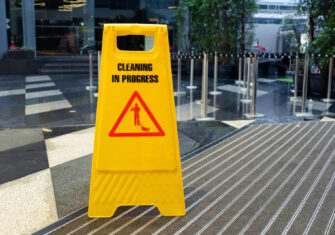 Yellow sign that says "Cleaning in Process" How Day Cleaning Mitigates Labor Shortages and Improved Work Environments