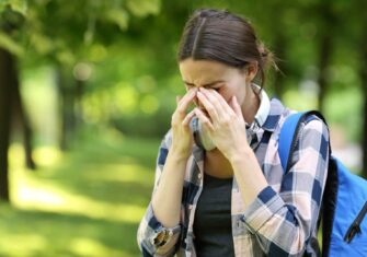 Woman student dealing with allergies How to Manage Indoor Air Quality During Allergy Season at Your Education Facility