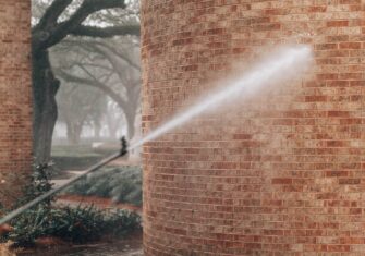 Power washing a brick wall Keep Students Safe and in School with These Pollen Power Washing Tips