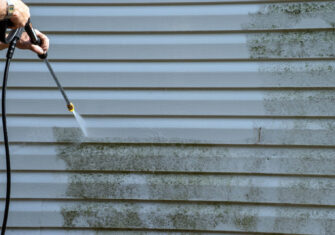 Pressure washing a dirty wall outside Top Ways Pressure Washing Enhances Curb Appeal and Attracts New Customers