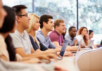 Students smiling in class Why You Should Know How Indoor Air Quality Affects Education Spaces