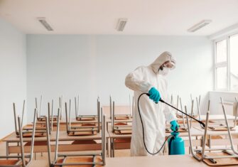 Man in sterile uniform Top 5 Places Your Education Facility Needs Deep Disinfection Services This Summer