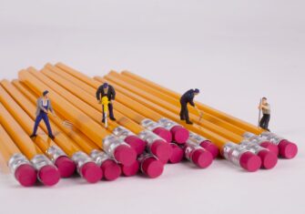 Miniature people worker during digging worker, digging yellow pencils. What to Add to Your Education Facility’s Summer Checklist and While Managing a Labor Shortage