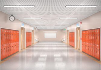 Tile floor in a school hallway with orange lockers. VCT vs. LVT: Why These Lower Maintenance Floors Help You with the Current Labor Shortage