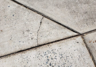 Crack in a sidewalk. How Warehouse Concrete Joint and Crack Repairs Will Minimize Liability Issues